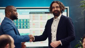 Two Power Apps developers shaking hands after project completion