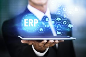 Man holding tablet screen in hand with logos showing ERP ad connectivity in Salesforce Consulting company