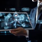 Man showing futuristic dashboard on laptop to show Power platform and AI for automation