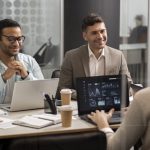 Salesforce Partners discussing salesforce implementation strategies with reports open on laptop